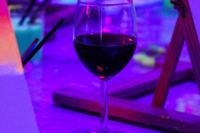 Paint a neon fluorescent picture while drinking unlimited wine - The canvas is the souvenir