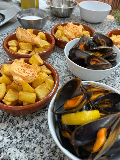 Valencia: Evening Guided Paella Workshop, Tapas, and Drinks - Sitting down to eat the paella you helped make